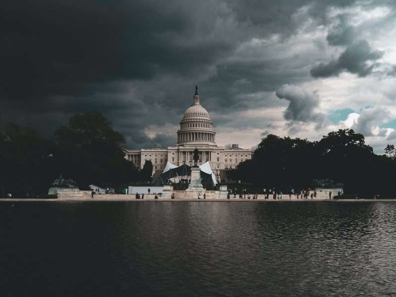dome building near body of water under cloudy sky