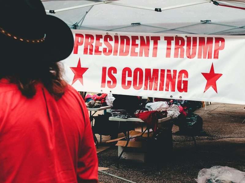 person standing beside canopy tent
