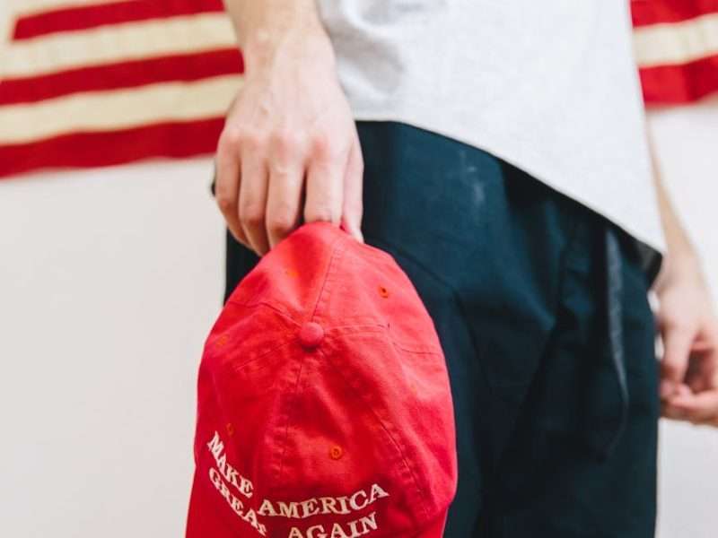 person holding red and black textile